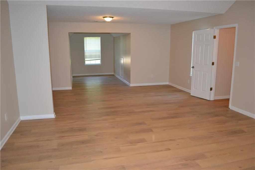 6157 Red Top Loop Union City, GA 30291 - Photo 16 of 26 an empty room with wooden floor and windows
