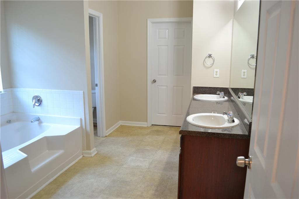 6157 Red Top Loop Union City, GA 30291 - Photo 18 of 26 a bathroom with a sink and a mirror