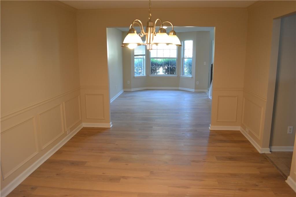 6157 Red Top Loop Union City, GA 30291 - Photo 4 of 26 an empty room with wooden floor and windows