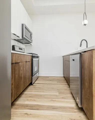 a view of a kitchen with wooden floor