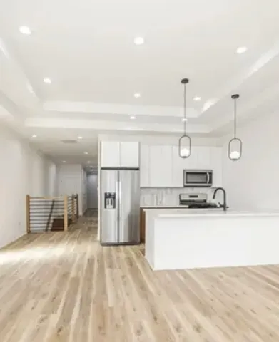 a large kitchen with a refrigerator a sink and a stove