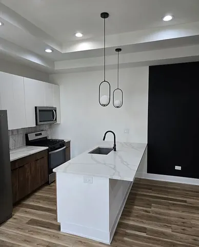 a kitchen with a refrigerator and a sink