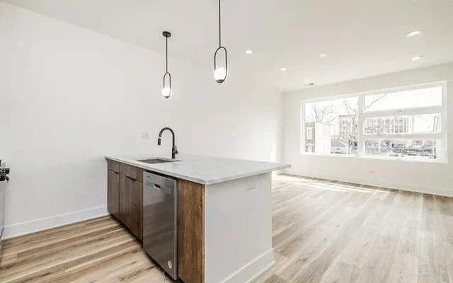 a view of a kitchen from the kitchen and a window