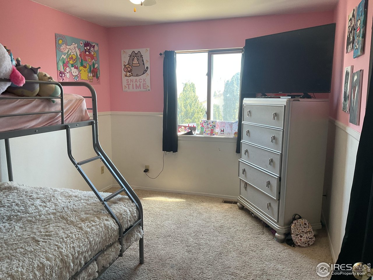 402 Gayle Street Fort Morgan, CO 80701 - Photo 27 of 40 a bedroom with a bed and a flat screen tv