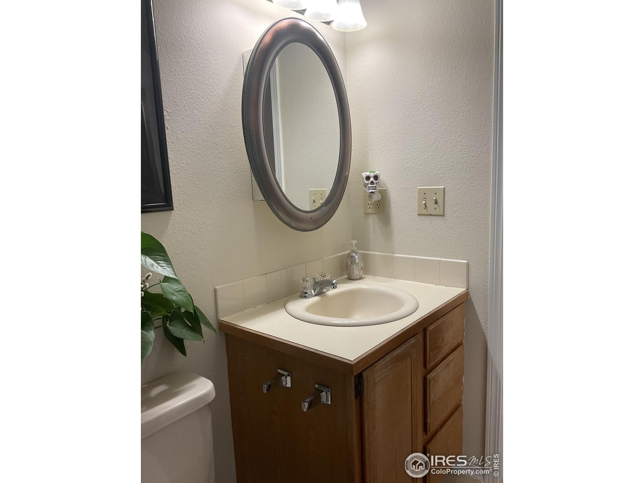 402 Gayle Street Fort Morgan, CO 80701 - Photo 35 of 40 a bathroom with a sink and a mirror