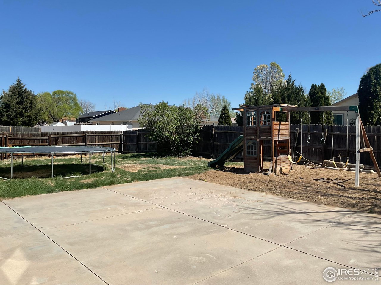 402 Gayle Street Fort Morgan, CO 80701 - Photo 37 of 40 a view of a house with backyard and trees