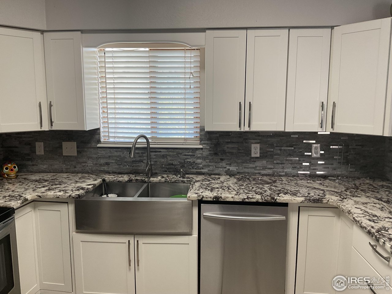 402 Gayle Street Fort Morgan, CO 80701 - Photo 7 of 40 a kitchen with granite countertop a sink and a white cabinets