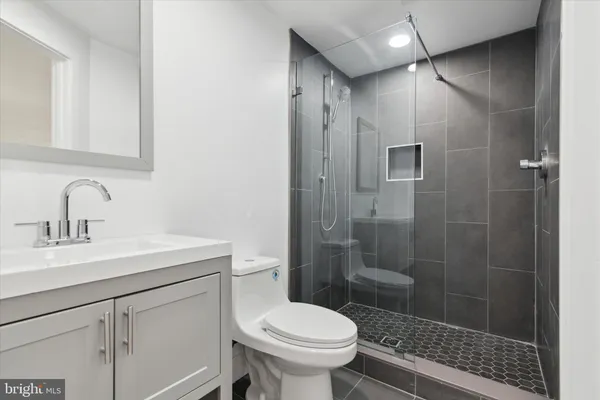 a bathroom with a sink toilet and shower