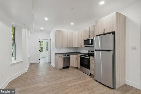 a kitchen with stainless steel appliances granite countertop a refrigerator microwave and stove
