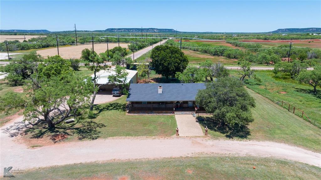 an aerial view of a house with a yard and lake view