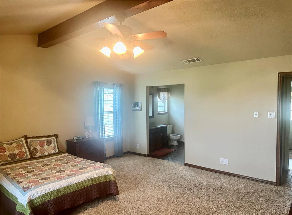4142 Highway 83 Tuscola, TX 79562 - Photo 8 of 28 a bedroom with a bed and a chandelier