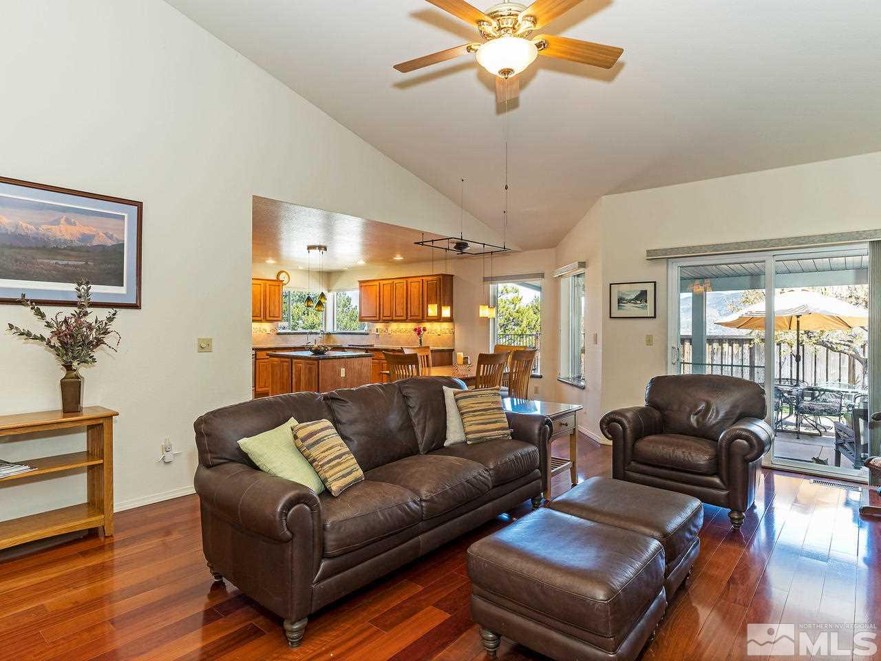 20 Targhee Court Reno, NV 89511 - Photo 4 of 16 a living room with furniture a ceiling fan and a large window