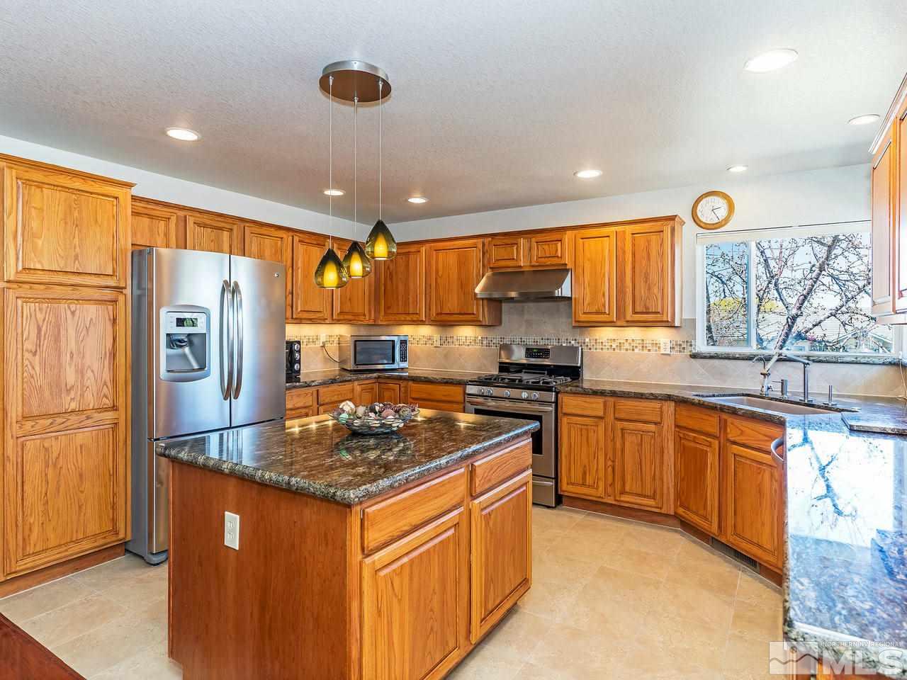 20 Targhee Court Reno, NV 89511 - Photo 6 of 16 a kitchen with stainless steel appliances granite countertop a sink stove and refrigerator