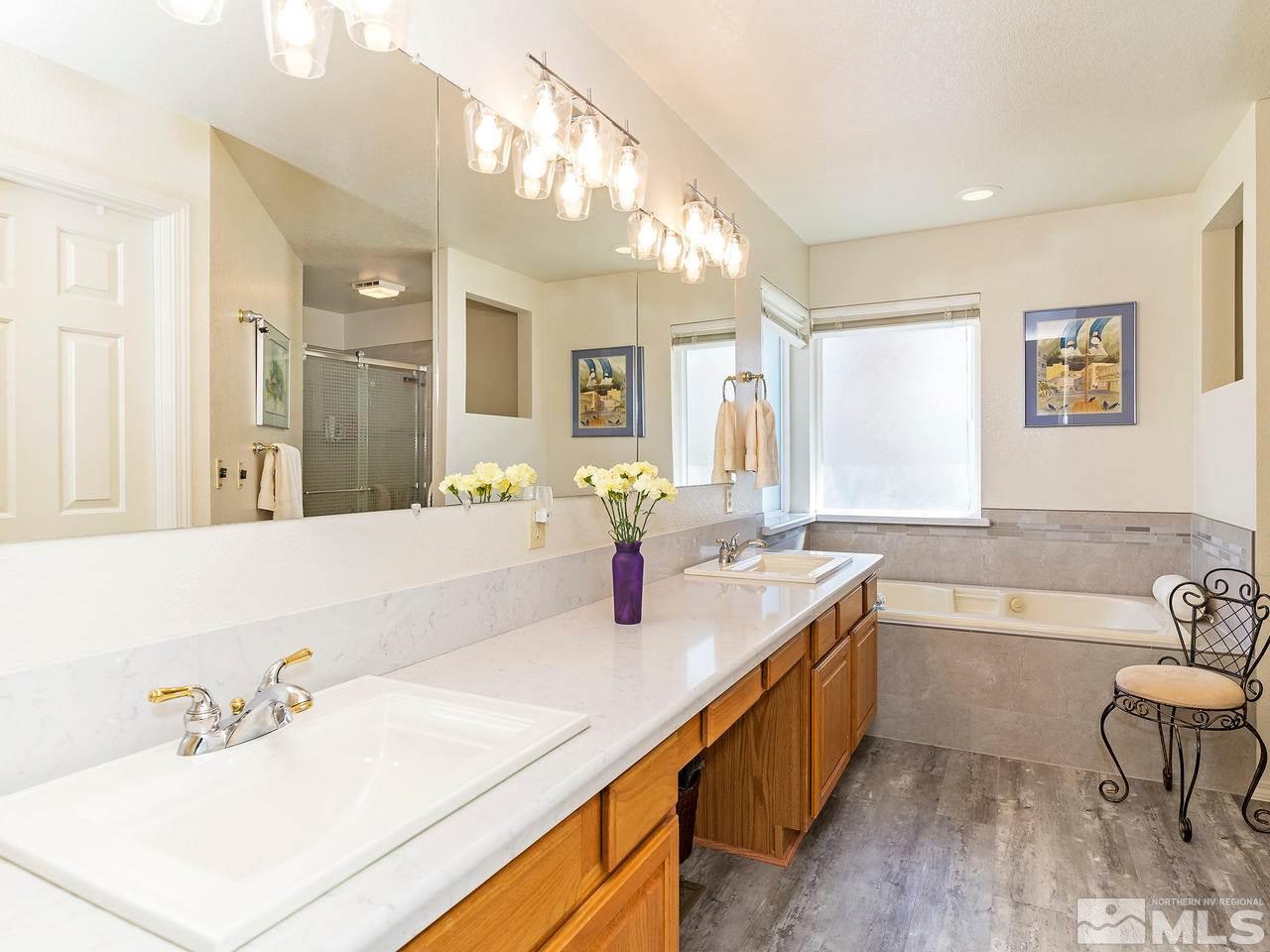 20 Targhee Court Reno, NV 89511 - Photo 10 of 16 a bathroom with a tub a sink and mirror