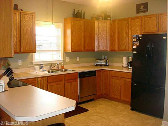 413 Barnsdale Ridge Road Kernersville, NC 27284 - Photo 4 of 15 Kitchen. Spacious Kitchen with lots of cabinets. Laundry closet and Garage access is here as well.