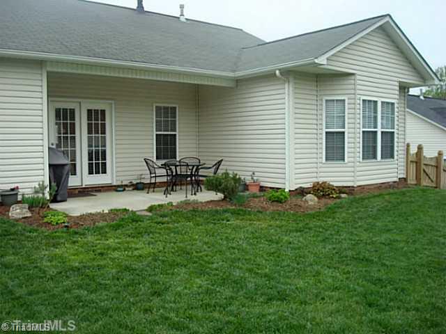 413 Barnsdale Ridge Road Kernersville, NC 27284 - Photo 10 of 15 Exterior Back. Covered Patio overlooking fenced in back yard.