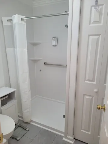 a bathroom with a shower and a toilet