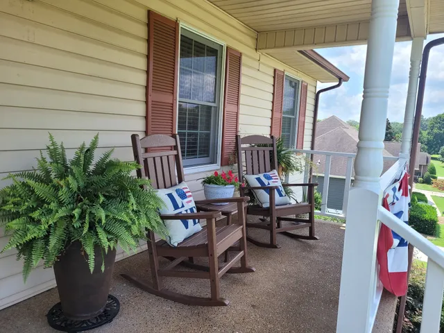 a view of a patio with couches and potted plants