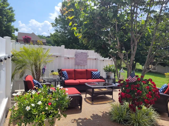 a backyard of a house with lots of green space and fountain view