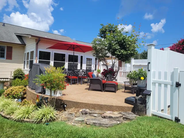 a view of a backyard with plants and a patio