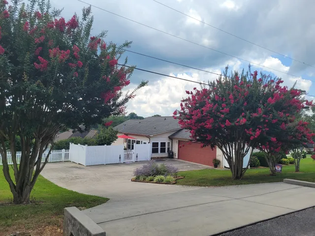 a view of a house with a yard and garage