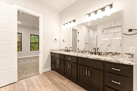 a bathroom with a sink double vanity and a mirror