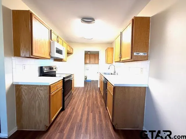 a kitchen with wooden cabinets and a sink