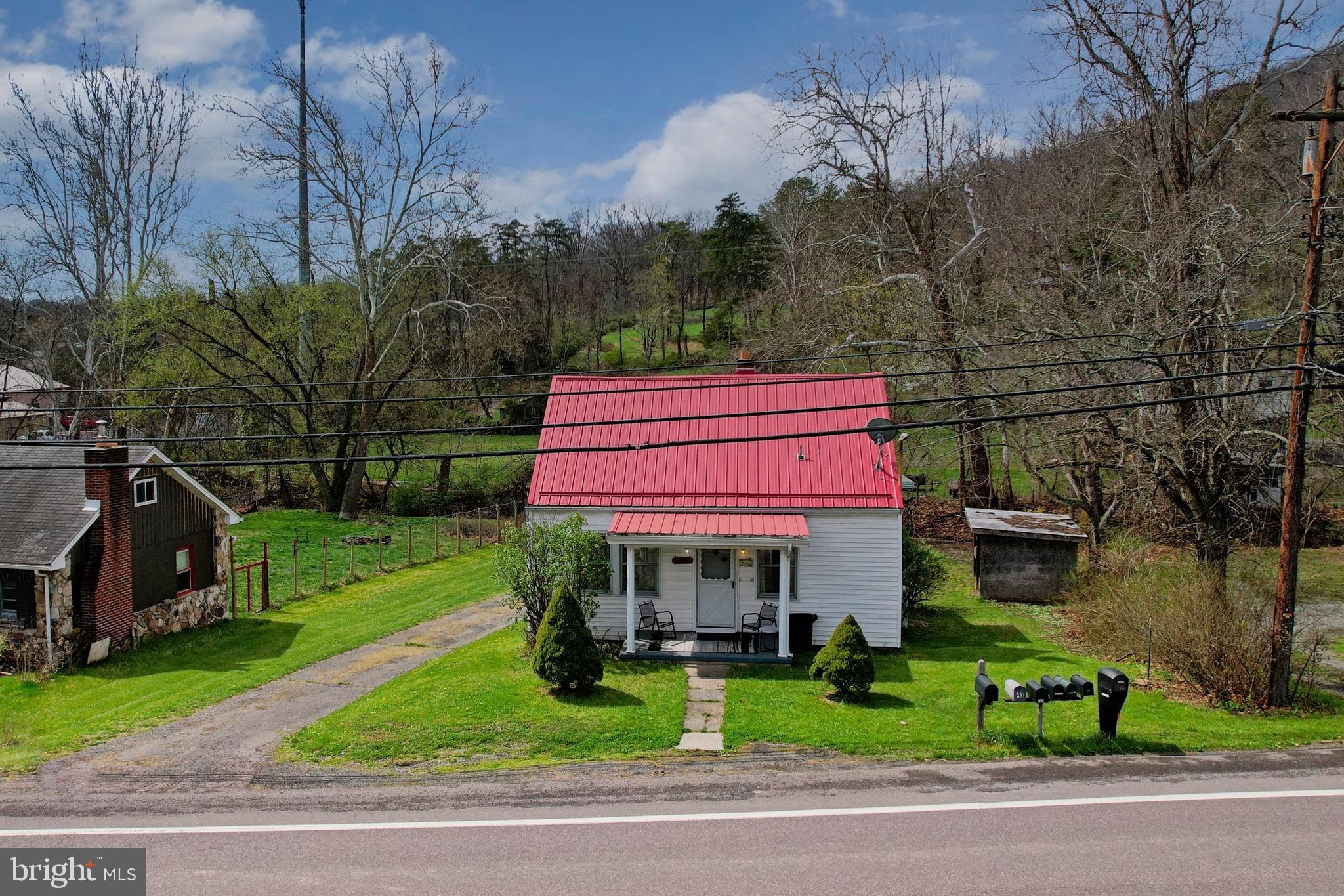 159 Rocket Center Road Keyser, WV 26726 - Photo 4 of 64 a front view of a house with a yard table and chairs