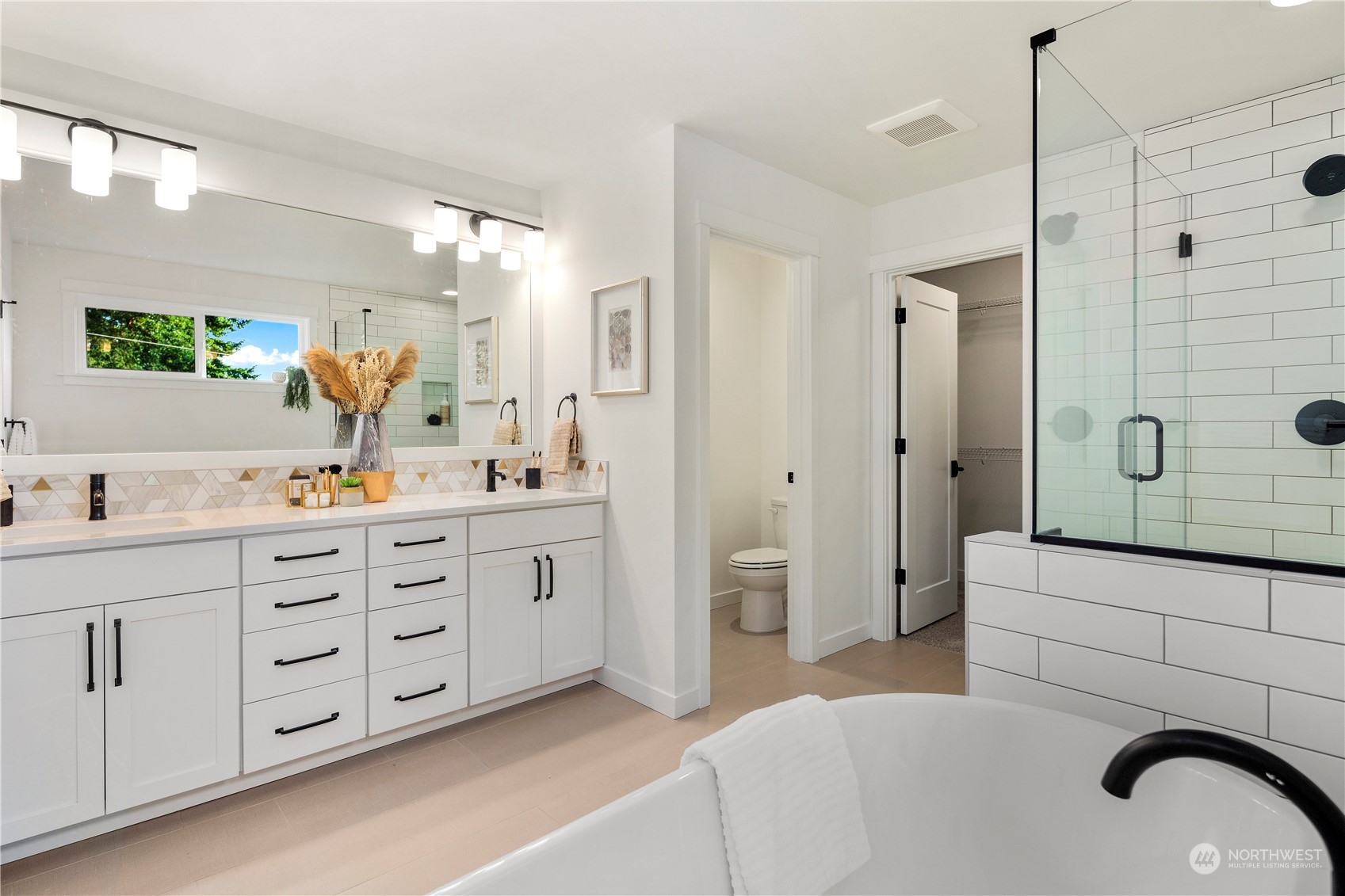 7 179th Place Southwest Bothell, WA 98012 - Photo 21 of 33 a spacious bathroom with a double vanity sink a mirror a shower and a bathtub