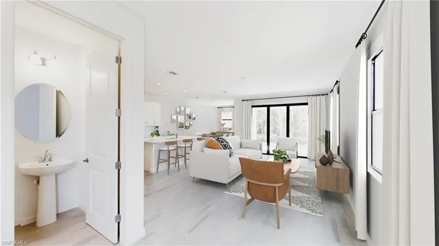 a work room with furniture a large window and glass doors