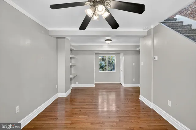 wooden floor in an empty room with a window