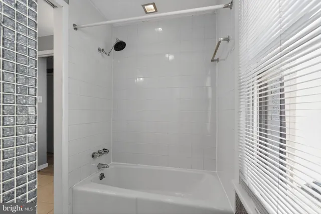 a bathroom with a bathtub and shower