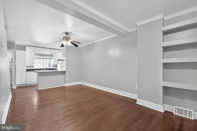 a view of kitchen with wooden floor electronic appliances and window