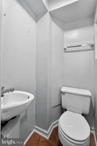 a white toilet sitting next to a bathroom sink