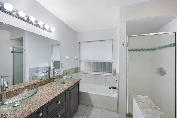 a bathroom with a granite countertop sink a toilet and shower