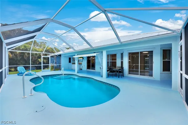 a view of a swimming pool with outdoor seating