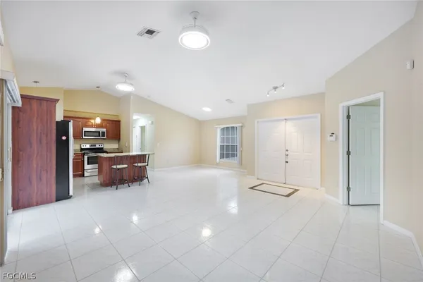 a view of a kitchen with refrigerator and a sink