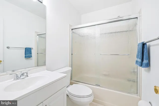 a bathroom with a sink a toilet and shower curtain