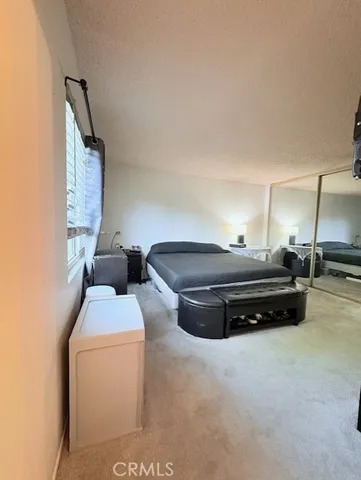 a bedroom with bed and a window