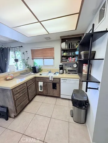a kitchen with a sink appliances and cabinets