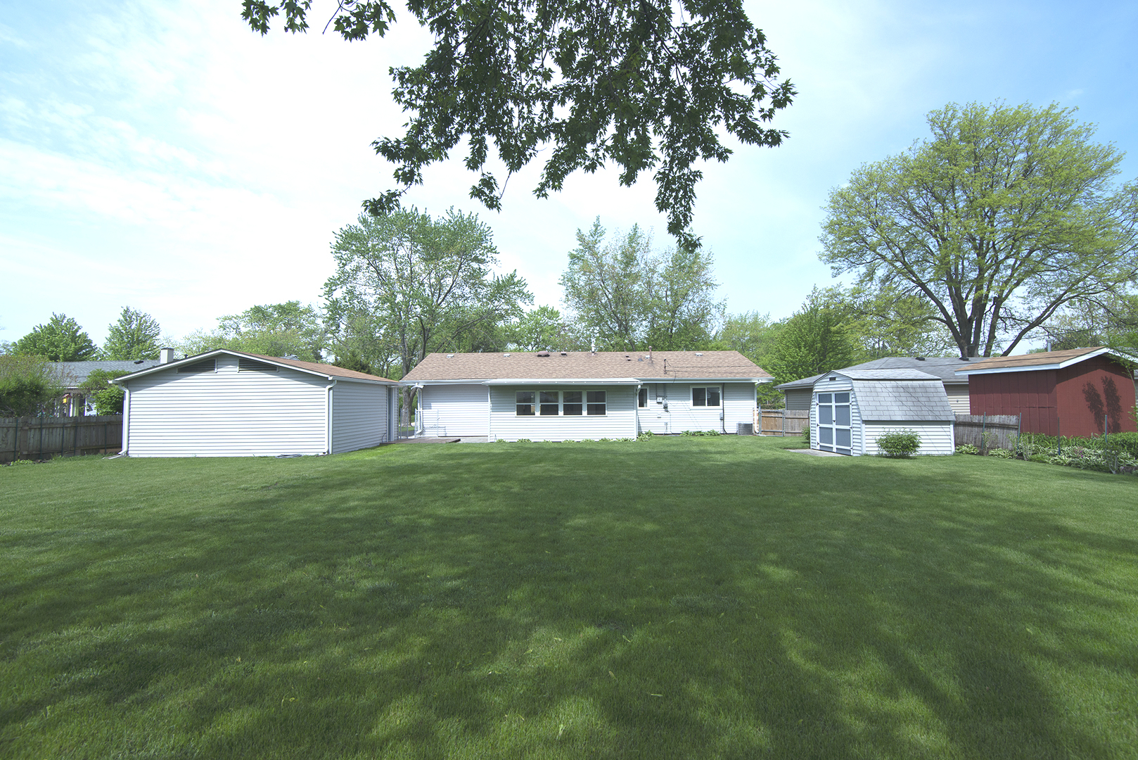 725 Washington Boulevard Hoffman Estates, IL 60169 - Photo 32 of 32 a view of a big house with a big yard and large trees