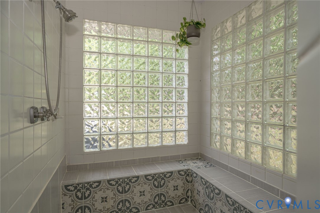 12700 Coalboro Road Chesterfield, VA 23838 - Photo 36 of 50 Shower enclosure featuring glass block walls, a bu