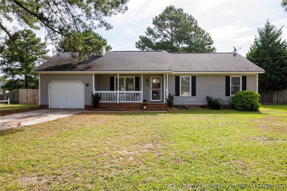 10205 Rockfish Road Raeford, NC 28376 - Photo 1 of 24 a front view of house with yard and trees around