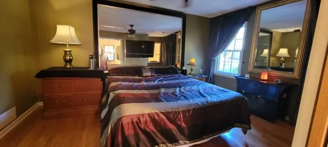 a bed sitting in a bedroom next to a lamp