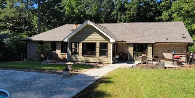a front view of a house with swimming pool and porch
