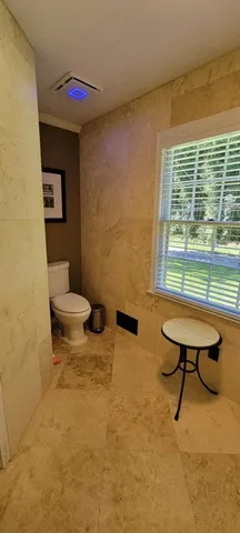 a bathroom with a sink toilet and a window