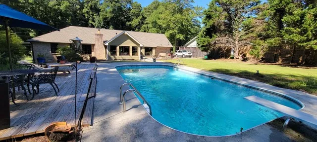 a view of a house with pool yard and sitting area