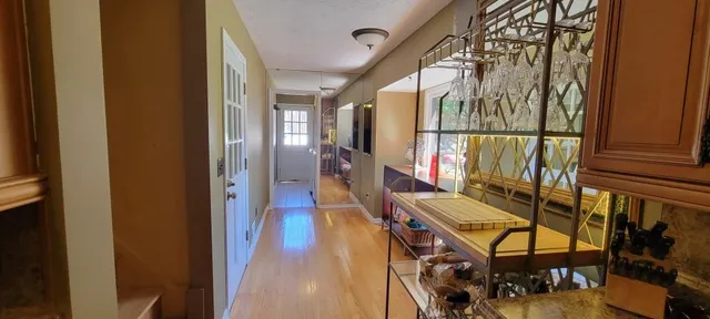 a view of an entryway with wooden floor