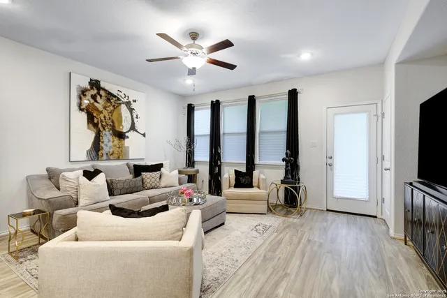 a living room with furniture and a flat screen tv