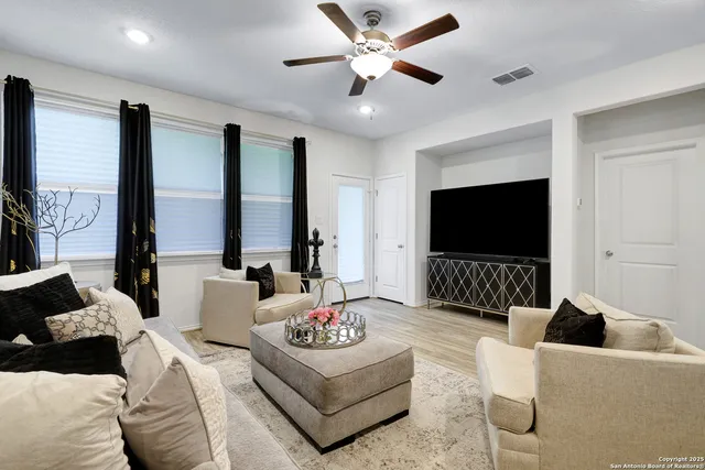 a living room with furniture and a flat screen tv